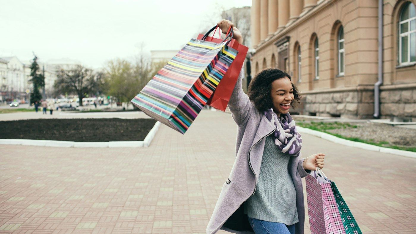 Happy woman holding shopping bags